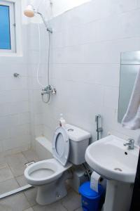 a bathroom with a toilet and a sink and a shower at Vista del mar homes in Malindi