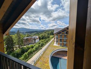 a view from the balcony of a hotel with a view at Harmony Valley Resort in Szklarska Poręba