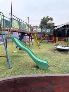 a playground with a slide in a park at Keylas Hotel in Ica