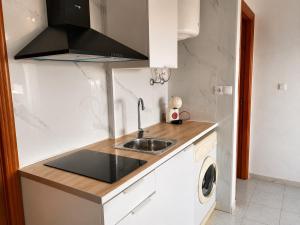 a kitchen with a sink and a washing machine at Estudio Torreblanca in Torrevieja