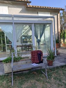 a bench in front of a conservatory with a window at La Casa dei Cavalli B&B Narni in Narni