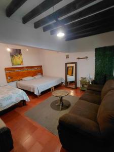 a living room with a couch and a bed at Casa xocolatl in San Miguel de Allende