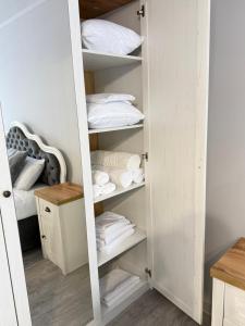 a closet with white shelves and white pillows at Boulevard terrace apartment in Chişinău