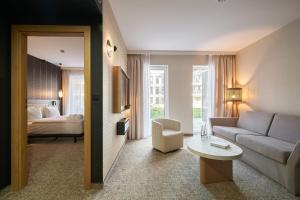 a living room with a couch and a bed at Harmony Valley Resort in Szklarska Poręba +58 photos
