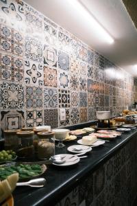 a buffet line with plates of food on at Villa di Serra by Concavus in Monte Verde