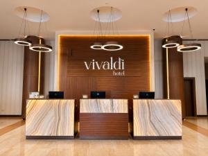 a lobby with a vaughn hotel sign on the wall at Vivaldi Hotel in St. Julianʼs