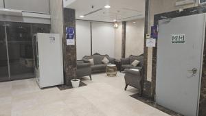 a lobby with couches and chairs in a building at فندق درة طيبة 3 in Az Zahrāʼ