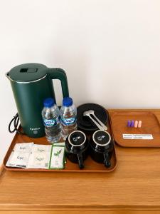 a table with a tea kettle and bottles of water at Padmasari Guest House in Canggu