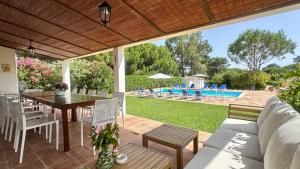 a patio with a table and chairs and a pool at Sol - Private Pool - 14 Guests - Vilamoura in Vilamoura +41 photos