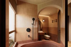 a bathroom with a shower and a toilet and a sink at LeCloud Dalat Hotel in Khu Chi Lăng