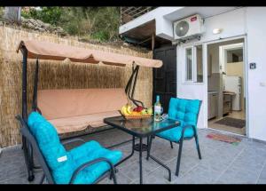 a patio with a table and chairs and a couch at Irinis studio in Rhodes Town