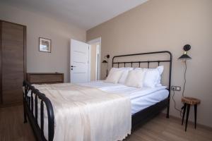 a bedroom with a large bed with white sheets and pillows at Monte Vista in Bansko