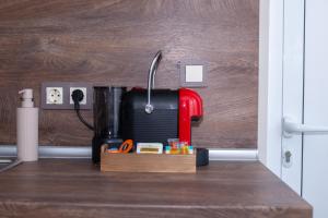 a kitchen counter with a red coffee maker on it at Monte Vista in Bansko