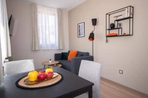 a living room with a table with fruit on it at Monte Vista in Bansko