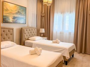 a hotel room with two beds and a window at Luxury Villa Aurelia in Peyia +24 photos
