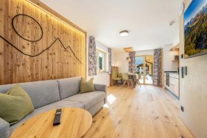 a living room with a couch and a table at Landhaus Lengg in Reit im Winkl