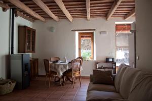 a living room with a table and a couch at Ca La Remei i Can Benet in Els Hostalets d'en Bas