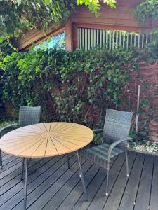 a wooden table and two chairs on a deck at Gästeappartement Appricot in Adendorf