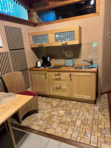 a small kitchen with a sink and a table at Gästeappartement Appricot in Adendorf