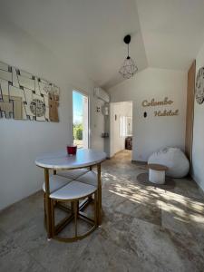 a table and a chair in a room at Maisonnette et Campagne Provençale, avec Piscine in Orgon +8 photos