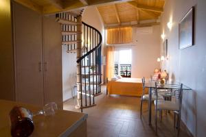 a living room with a spiral staircase leading to a bedroom at Grand Resort nefeli in Vasiliki