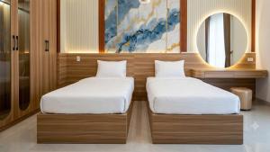 two beds sitting next to each other in a room at Mai Song Linh in Phan Rang–Tháp Chàm +11 photos