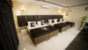 a hotel room with two beds at White Shell Hotel in Karachi