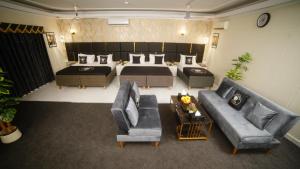 a large living room with a bed and a couch at White Shell Hotel in Karachi