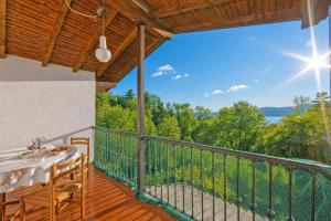 a patio with a table and chairs on a balcony at Villa La Verbanina Private Garden - Happy Rentals in Ghiffa