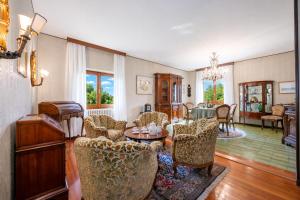a living room with chairs and a table at Villa La Verbanina Private Garden - Happy Rentals in Ghiffa