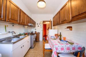 a kitchen with a table and a sink at Villa La Verbanina Private Garden - Happy Rentals in Ghiffa