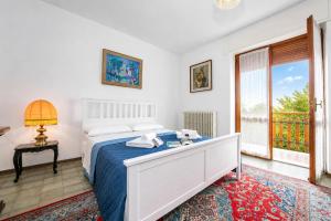 a bedroom with a bed and a window at Villa La Verbanina Private Garden - Happy Rentals in Ghiffa +32 photos