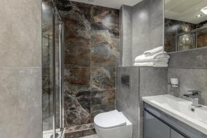a bathroom with a toilet and a shower and a sink at Diff-Rent Studios with gym & Fast Access to Central London & Wembley in Harrow