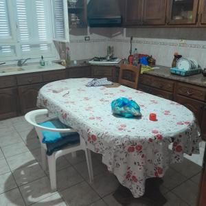 a kitchen with a table with a table cloth on it at Grande maison de vacances 250m2 in Rejiche