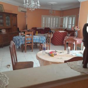 a living room with tables and chairs and a couch at Grande maison de vacances 250m2 in Rejiche