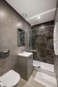 a bathroom with a toilet sink and a shower at Diff-Rent Studios with gym & Fast Access to Central London & Wembley in Harrow