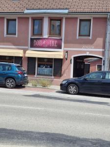 two cars parked in front of a building at penzion BON TRE in Třeboň