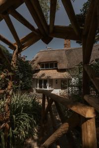 a thatch roofed house with a thatched roof at Hathaway Hamlet in Stratford-upon-Avon