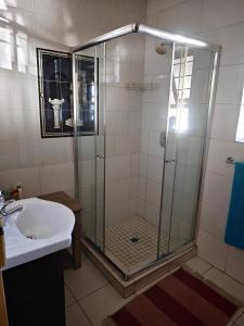 a bathroom with a shower and a sink at Stay & unwind in Alberton +14 photos