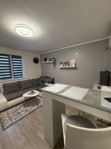 a living room with a couch and a table at Apartman Indy in Marčelji