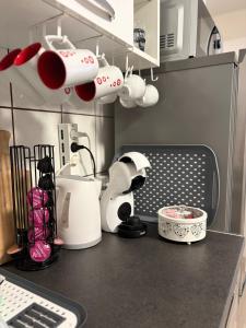 a kitchen counter with cups and appliances on it at Apartman Indy in Marčelji +9 photos