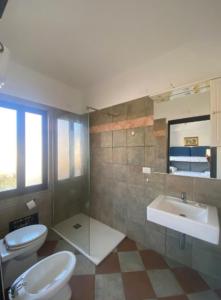 a bathroom with two toilets and a sink at Daluef Alloggi in Assemini +93 photos