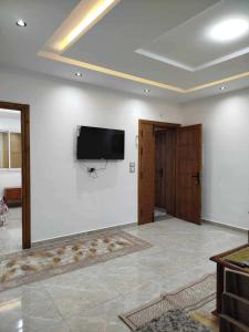 a living room with a flat screen tv on a wall at Lemjid maison in Kelibia