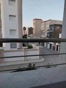 a view of a city street from a balcony at Lemjid maison in Kelibia
