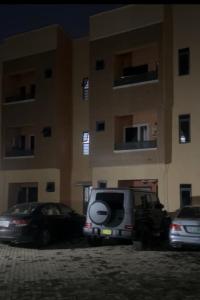 a vehicle parked in a parking lot in front of a building at Esthella Property in Ijaiye