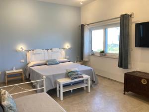 a bedroom with a bed and a window and a couch at Tra Cielo e Mare - Monopoli in Impalata