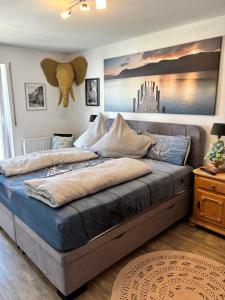 a bedroom with a large bed with blue sheets at Luckylake in Muhr amSee