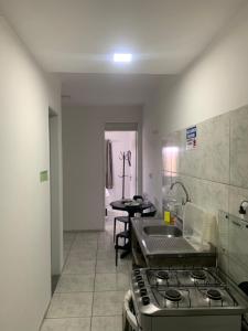 a kitchen with a stove and a sink in it at Fortal Flat in Fortaleza +111 photos