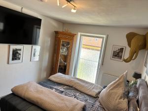 a room with a couch and an elephant on the wall at Luckylake in Muhr amSee