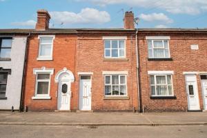 a red brick house with white doors and windows at Family Friendly I Pets Welcome I Short Walk to Railway Station I 10min Drive to Safari Park in Kidderminster